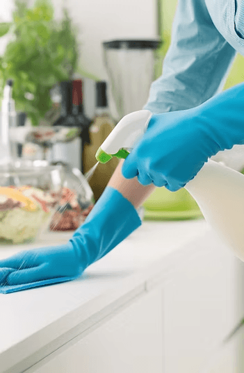 Cleaner wiping down a counter